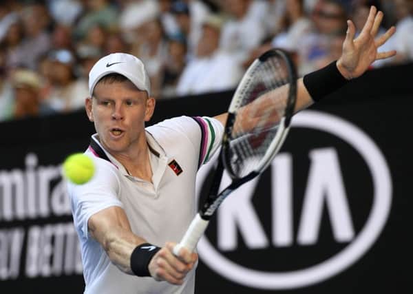 Britain's Kyle Edmund makes a backhand return to Tomas Berdych of the Czech Republic during their first round match at the Australian Open tennis championships in Melbourne. (AP Photo/Andy Brownbill)