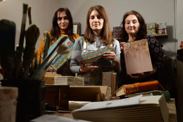 Parveen Hussain, Moneeza Khan and Farida Khan at Lotus Blu Book Art in Bradford, where they create handmade books including wedding guest books and photo albums, which have attracted interest around the world. (Bruce Rollinson).