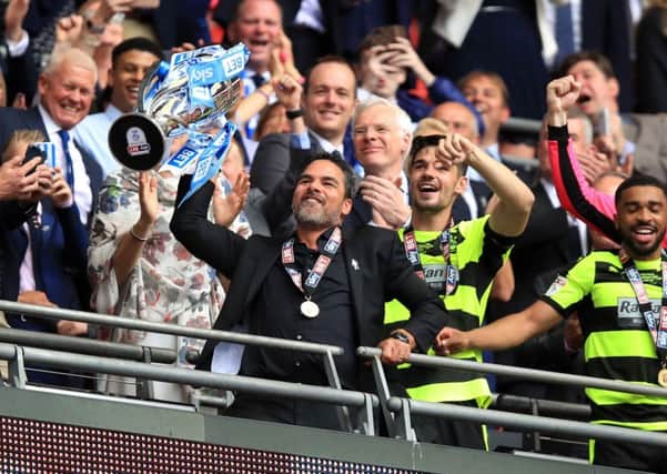 Huddersfield Town manager David Wagner celebrates with the trophy after winning the Sky Bet Championship play-off final at Wembley.