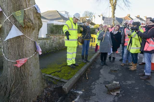 Workers from Amey prepare the road around  a tree on Chatsworth Road in sheffield for remedial work. Nick Hetherington explains the course of work that will be carried out to STAG members
