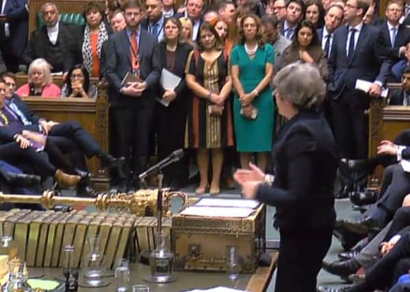 Theresa May addresses the Commons after losing her Brexit vote.