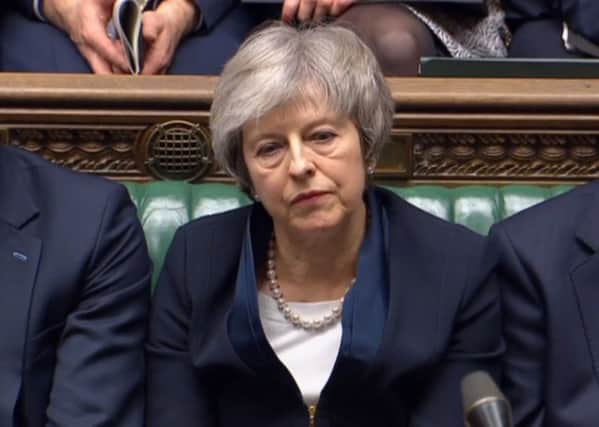 Prime Minister Theresa May listens to Labour leader Jeremy Corbyn speaking after losing a vote on her Brexit deal in the House of Commons. PIC: PA
