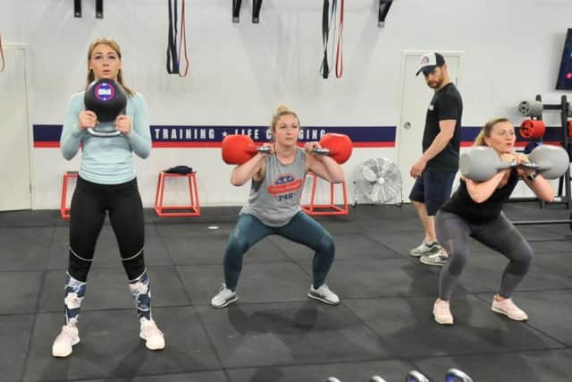 Manager Andy Preston (left)  keeping an eye on a  class taking place at F45 Gym in Harrogate  with Nina Swift  in the middle.