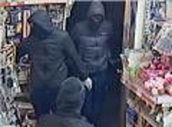 Police investigating an attempted robbery want to identify the men in this image.