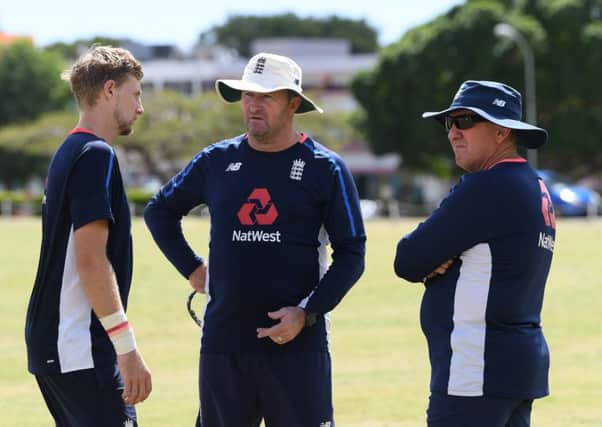 DECISIONS, DECISIONS: England assistant coach Paul Farbrace, middle, talks with captain Joe Root, left, and head coach Trevor Bayliss during net practice in Bridgetown. Picture: Shaun Botterill/Getty Images)