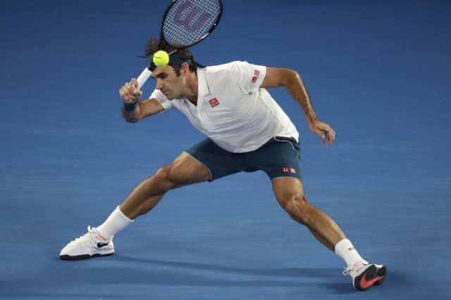 NEXT: Switzerland's Roger Federer makes a forehand return against States' Taylor Fritz in Melbourne. Picture: AP/Kin Cheung