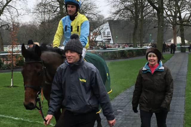 Assistant trainer Ryan Clavin, and Susan Cook, lead Danny Cook and Wakanda into the Haydock winner's enclosure.