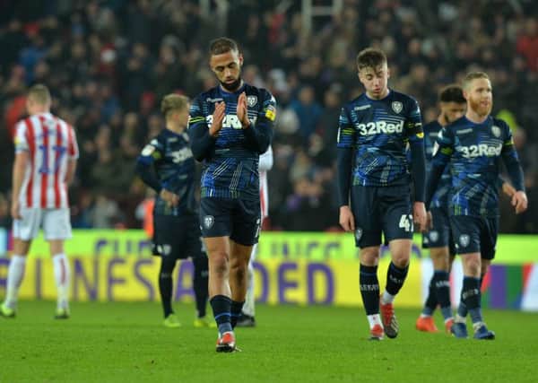 Kemar Roofe, centre, takes time to applaud Leeds Uniteds travelling fans as the side trudge back to the dressing rooms after losing 2-1 to Stoke City (Picture: Bruce Rollinson).