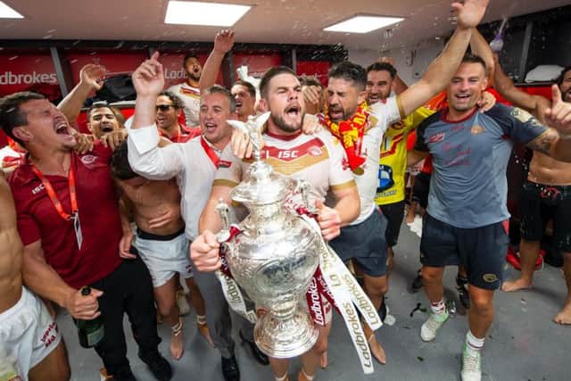 Catalans captain Remi Casty (with Challenge Cup) leads the celebrations after their famous 2018 Wembley win over Warrington Wolves. (SWPix)