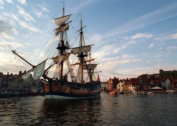 A replica of HMS Bark Endeavour sails into Whitby Harbour.