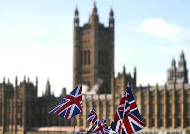 Union flags fly in front of Parliament during a Brexit debate.