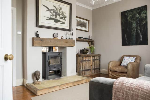 The old sitting room is now a cosy snug with a log burning stove that heats the rooms on either side. Robert made the unit to the right of the fireplace.