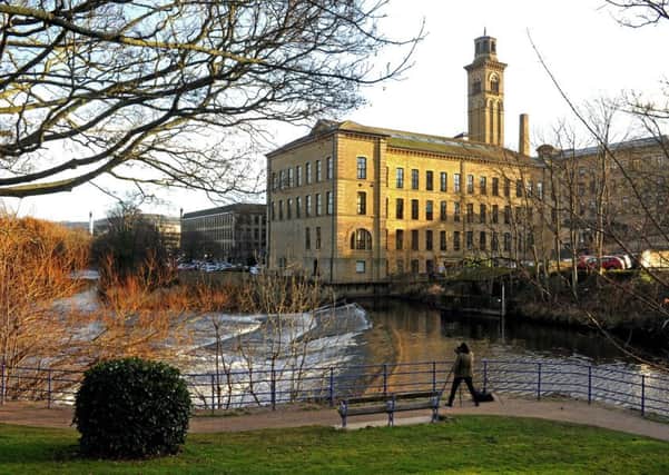 A photographer pictures the River Aire as it passes New Mill in Saltaire. Picture Tony Johnson.