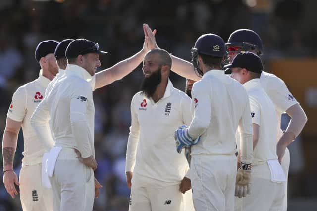 England celebrate one of three wickets taken by Moeen Ali, centre, during the West Indies' second innings (Picture: Ricardo Mazalan/AP).