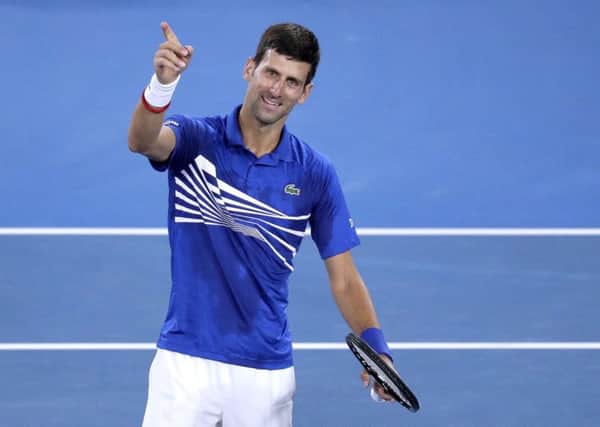 Serbia's Novak Djokovic celebrates after defeating France's Lucas Pouille in their semifinal at the Australian Open. (AP Photo/Kin Cheung)