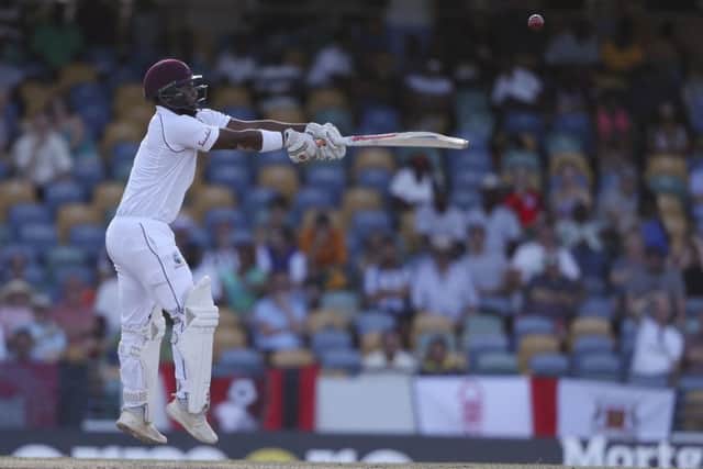 West Indies' John Campbell plays a shot from the bowling of England's Ben Stokes during day two of the first cricket Test match at the Kensington Oval in Bridgetown, Barbados. (AP Photo/Ricardo Mazalan)