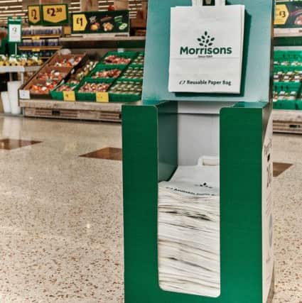 Pictures to show how Morrisons is giving customers the option of using large paper carrier bags in eight of its stores from this week.