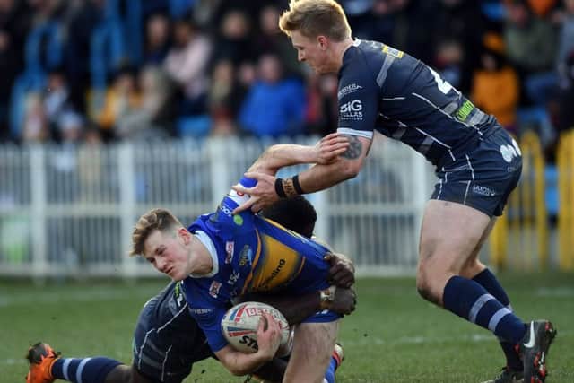 Featherstone's Ase Boas and Connor Carey get to grips with Liam Whitton. PIC: Jonathan Gawthorpe