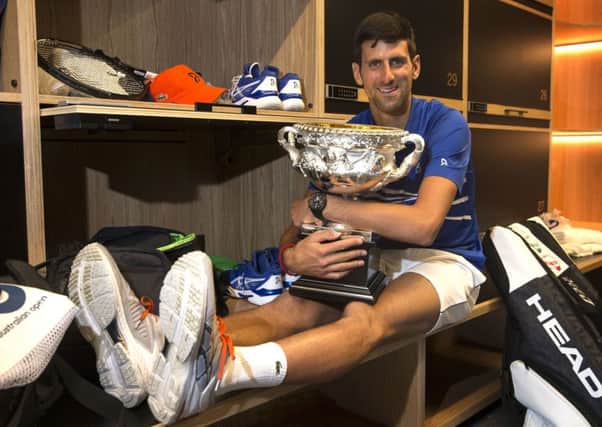 Serbia's Novak Djokovic holds the Norman Brookes Challenge Cup in the men's locker room after defeating Spain's Rafael Nadal in the men's singles final at the Australian Open (Picture:(Fiona Hamilton/Tennis Australia via AP).