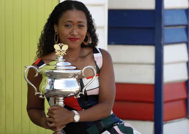 Japan's Naomi Osaka holds her the Daphne Akhurst Memorial Cup at Melbourne's Brighton Beach following her win over Petra Kvitova at the Australian Open (Picture: Aaron Favila/AP).