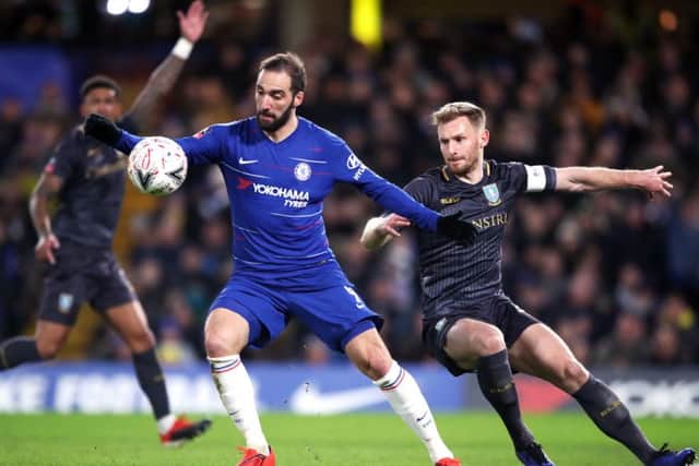 Chelsea's Gonzalo Higuain (left) and Sheffield Wednesday's Tom Lees battle for the ball at Stamford Bridge. Picture: Nick Potts/PA