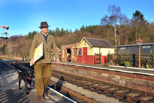 Chris Ware watercolour artist at Levisham station on the North York Moors railway with his dog Rumba.