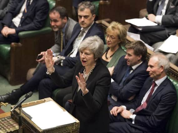 Theresa May addresses the Commons during the debate today.