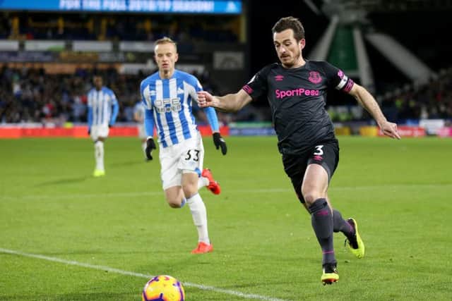 Everton's Leighton Baines (right) and Huddersfield Town's Florent Hadergjonaj battle for the ball at the John Smith's Stadium. Picture: Nigel French/PA