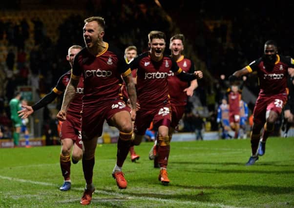 David Ball and Bradford City team-mates celebrate his stoppage-time winner against Shrewsbury Town on Tuesday night (Picture: Bruce Rollinson).