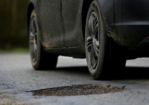 Who should be responsible for repairing potholes?