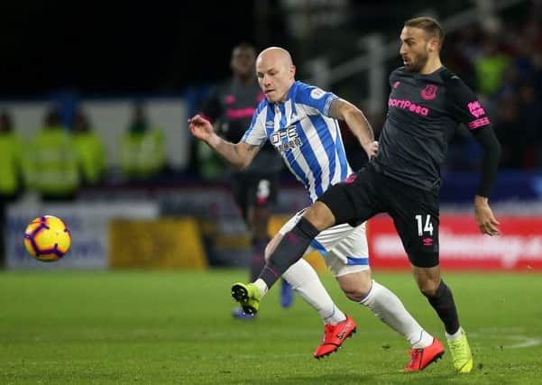 Huddersfield Town's Aaron Mooy (left) and Everton's Cenk Tosun battle for the ball.