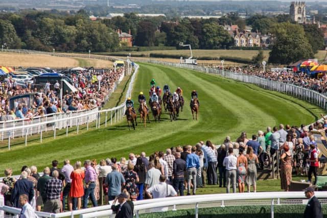 A typical raceday scene at Beverley with the town's Minster in the background.