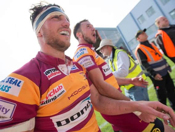 Scott Grix, left, celebrates with Ryan Brierley after helping Huddersfield Giants to victory at Hull KR - and avoiding relegation - in September 2016, his last game for the club. (SWPix)