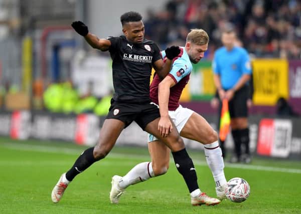UP FOR IT: Barnsley's Dimitri Cavare (left) challenges Burnley's Charlie Taylor during the FA Cup encounter last month. Picture: Dave Howarth/PA.