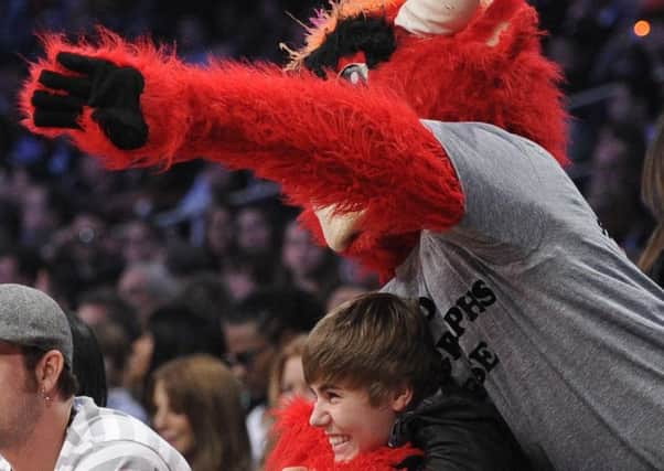 Appealing to the masses: The Chicago Bulls basketball mascot jokes around with Justin Bieber.
