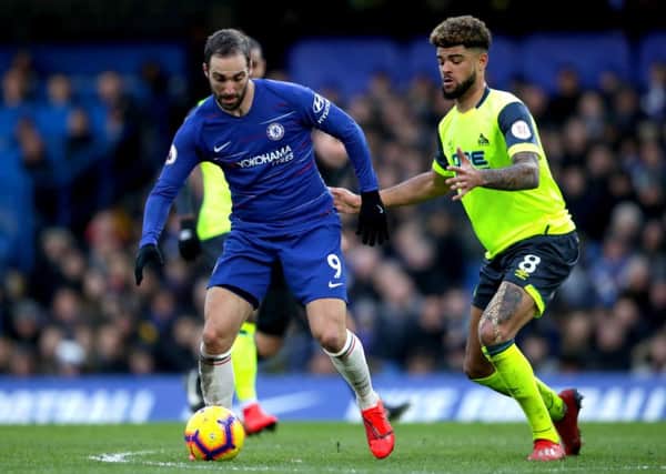 On the ball: Chelsea's Gonzalo Higuain and Huddersfield Town's Philip Billing battle for possession.