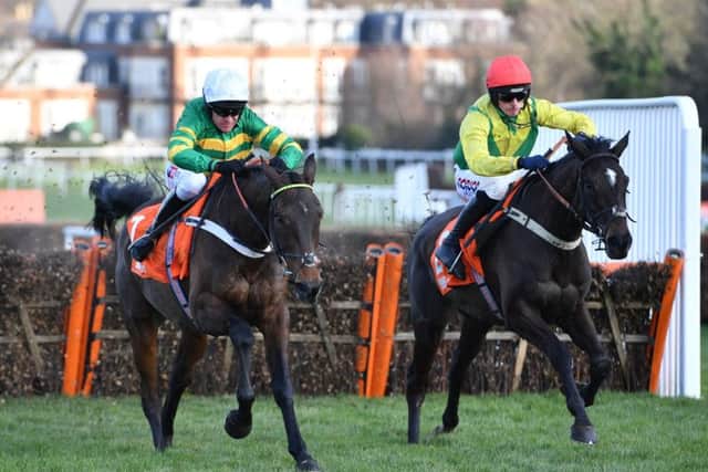 Barry Geragthy and Buveur D'Air (left) win the Contenders Hurdle at Sandown.