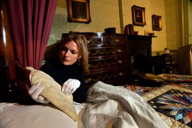 Curator Sarah Laycock puts the finishing touches to the display in Patrick Bronte's bedroom, placing his nightcap before the museum opens its doors. Picture: Bruce Rollinson