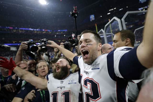 New England Patriots' Julian Edelman, left, and Tom Brady celebrate after the NFL Super Bowl 53 football game against the Los Angeles Rams (AP Photo/David J. Phillip)