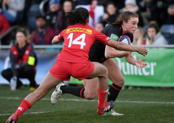 Going through: England's Kelly Smith gets away from Canada's Magali Harvey to score a try at Castle Park. Picture: Jonathan Gawthorpe