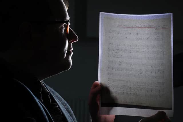 Dr Dominic McHugh is pictured with one of the music sheets.