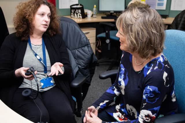 Dame Esther Rantzen talks to a volunteer with The Silver Line charity.