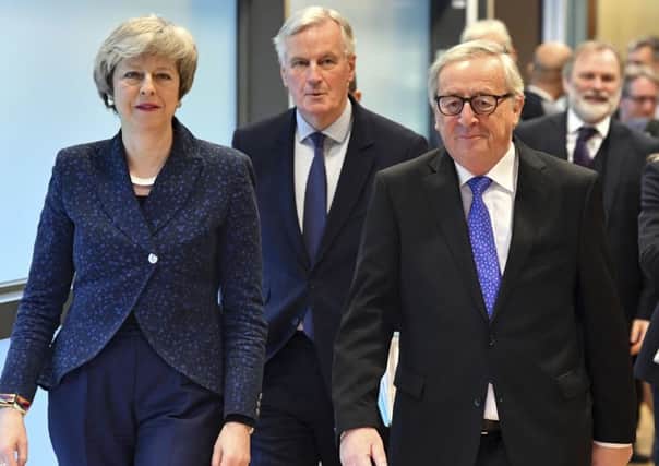 Theresa May with Michel Barnier and Jean-Claude Juncker during Brexit talks last Thursday.