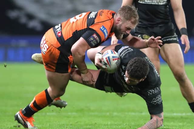TAKE THAT: Hakim Miloudi of Hull FC is bundled over by Castleford's Paul McShane. Picture: Ash Allen/SWpix.com
