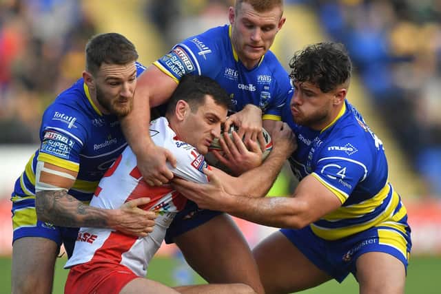 Hull KR's Craig Hall is wrapped up by the Warrington defence. (PIC: Dave Howarth/PA Wire)