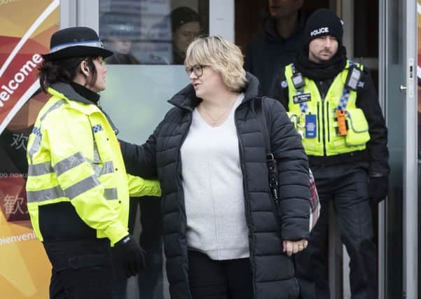 Lisa Squire, the mother of missing student Libby Squire, hugs a police officer on leaving a service at Hull Community Church. PIC: PA