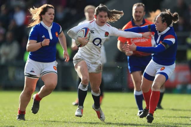 England's Leanne Riley is tackled by France's Pauline Bourdon.