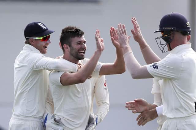 England's Mark Wood is embraced by team captain Joe Root as he celebrates taking the wicket of Roston Chase in St. Lucia. Picture: AP/Ricardo Mazalan