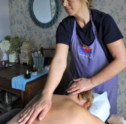 Claire Ellis the owner of  'My Little Farm Spa'  at Norristhorpe  giving a massage in one of the treatment rooms .