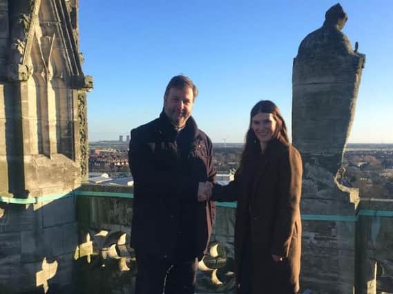 Vicar of Selby Abbey, The Reverend Canon John Weetman, and Hayley Silvester, Head of Sales, Quickline, on top of Selby Abbey